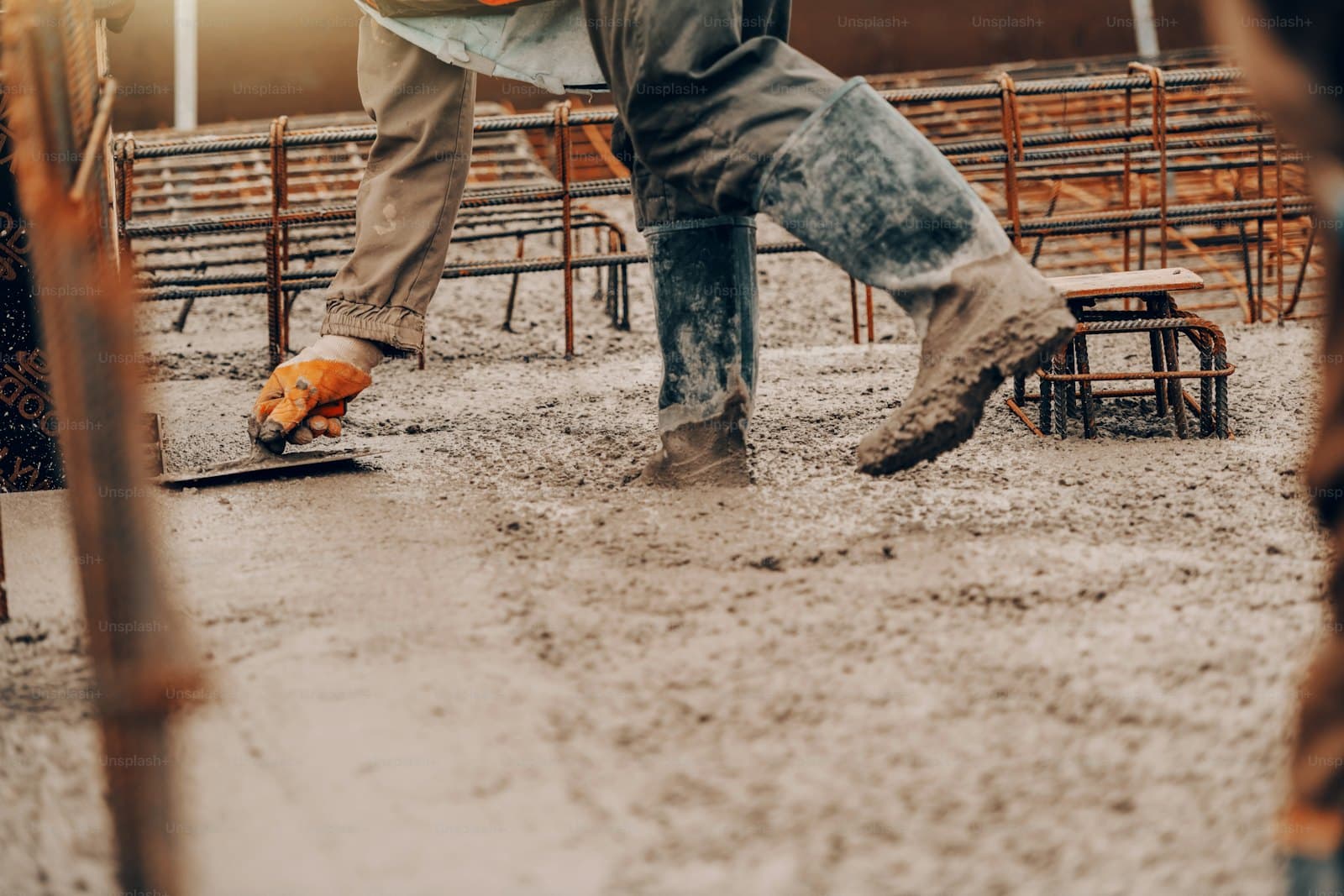 Vakman werkt een natte betonvloer af met een spaan